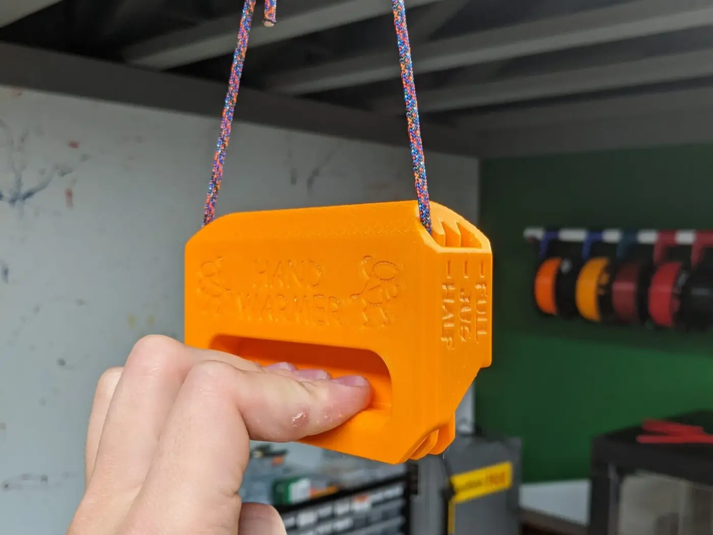 The 3D printed grip strength trainer that started Remote, hanging from a length of cord.